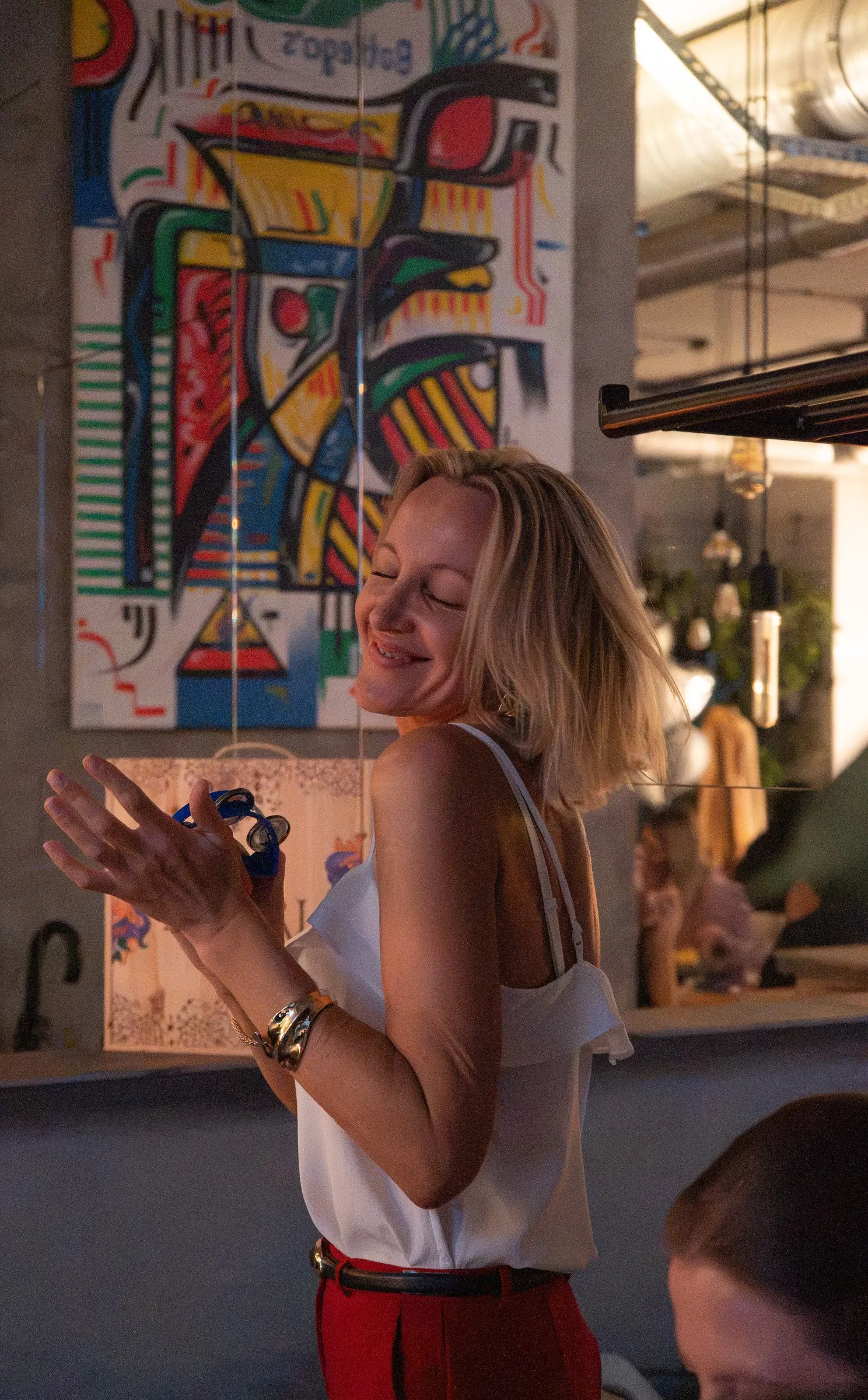Dancing by the colourful mural during a party at Bottegas, ul. Oboźna 9
