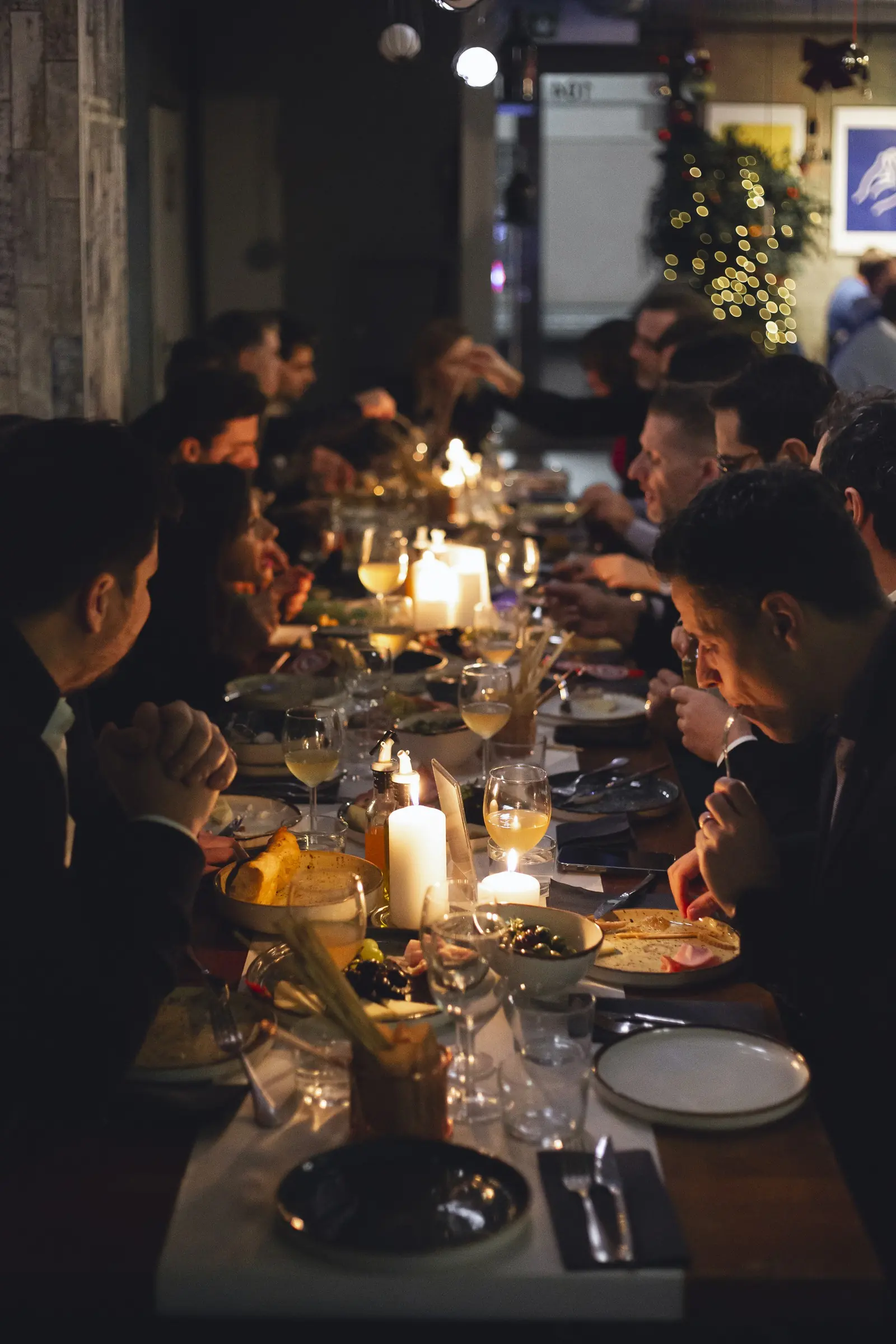 A company dinner at a long candlelit table at Bottegas, ul. Oboźna 9