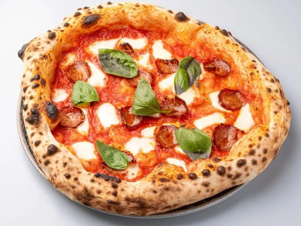 Diavola pizza with spicy salami and a tall, charred crust